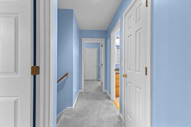 corridor featuring light colored carpet