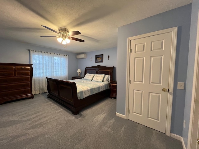 bedroom with ceiling fan, a wall mounted air conditioner, a textured ceiling, and carpet flooring