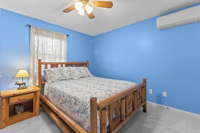 carpeted bedroom featuring an AC wall unit and ceiling fan