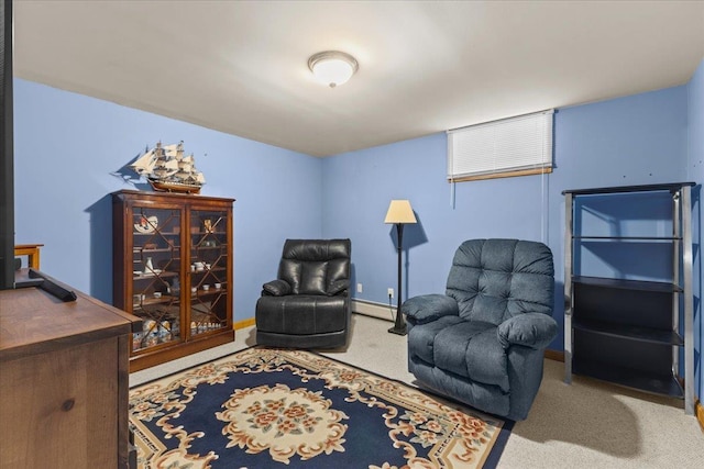 living area with carpet and a baseboard heating unit