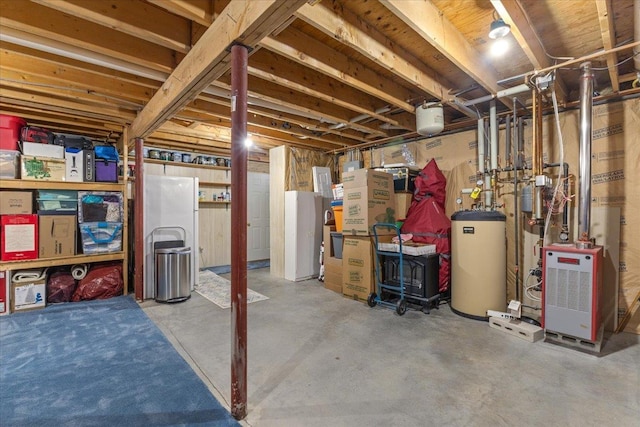 basement featuring gas water heater and white fridge