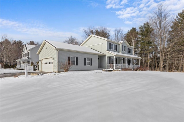 view of property with a garage and a porch