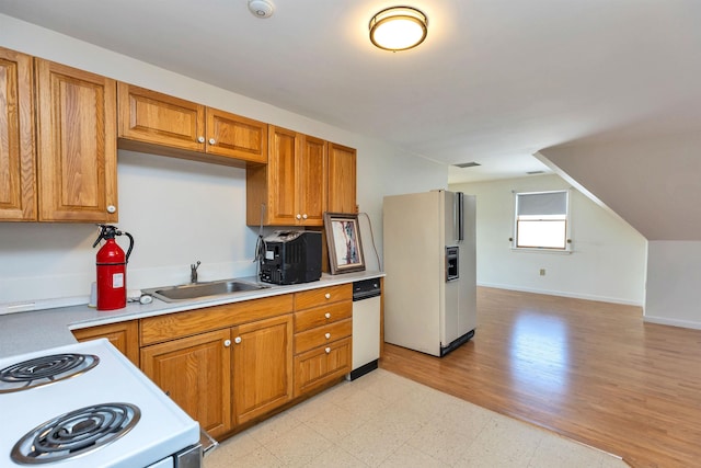 kitchen with lofted ceiling, sink, and white appliances