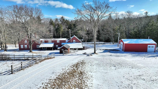 yard covered in snow with an outbuilding