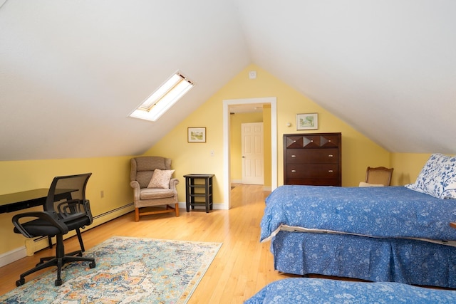 bedroom with lofted ceiling with skylight and hardwood / wood-style floors