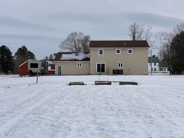 view of snow covered rear of property