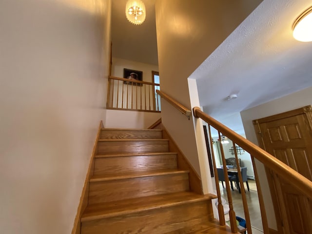 stairway with a chandelier