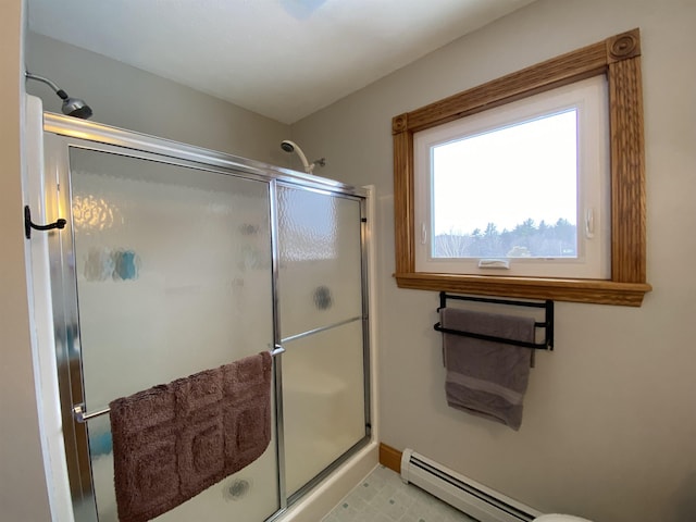 bathroom with a shower with door and a baseboard heating unit