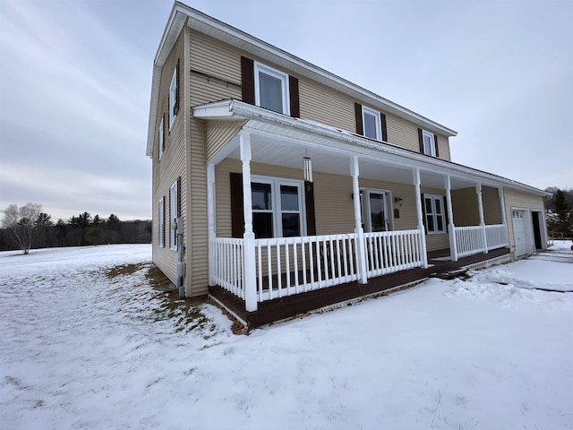 view of front of property featuring a porch and a garage