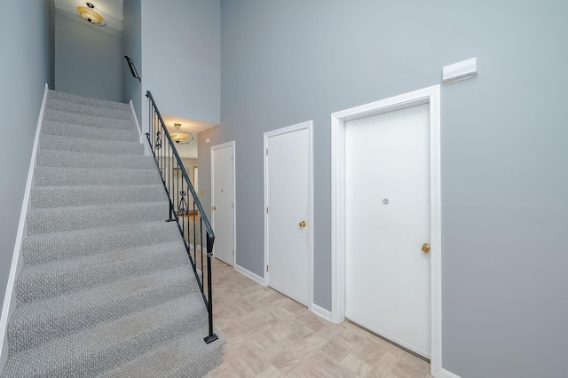 staircase featuring a high ceiling