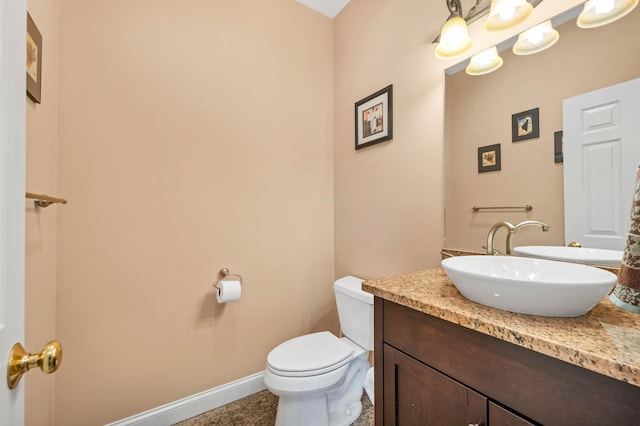 bathroom with toilet, tile patterned flooring, and vanity