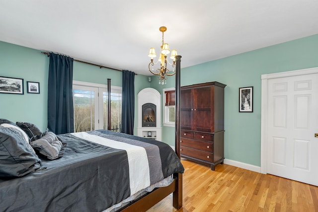 bedroom featuring a chandelier and light hardwood / wood-style flooring