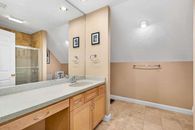 bathroom with toilet, vanity, tile patterned flooring, vaulted ceiling, and walk in shower