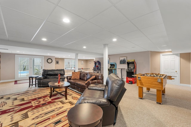 carpeted living room with a paneled ceiling