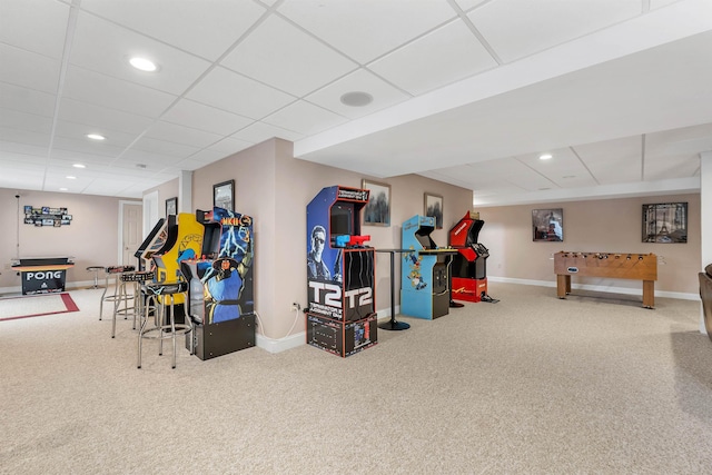 rec room with carpet floors and a paneled ceiling