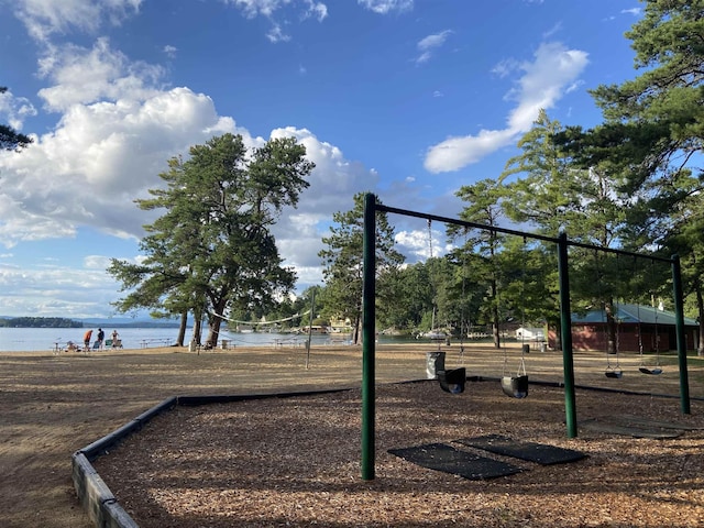 view of property's community featuring volleyball court and a water view