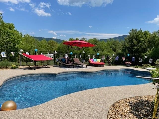 view of swimming pool featuring a mountain view