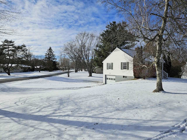 snowy yard with a garage