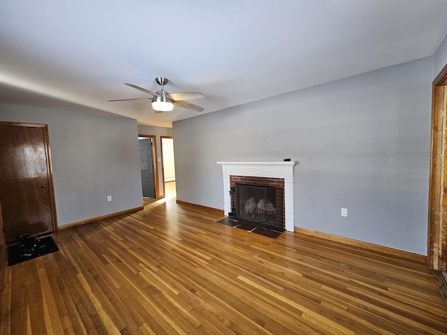 unfurnished living room featuring ceiling fan, a fireplace, and hardwood / wood-style floors