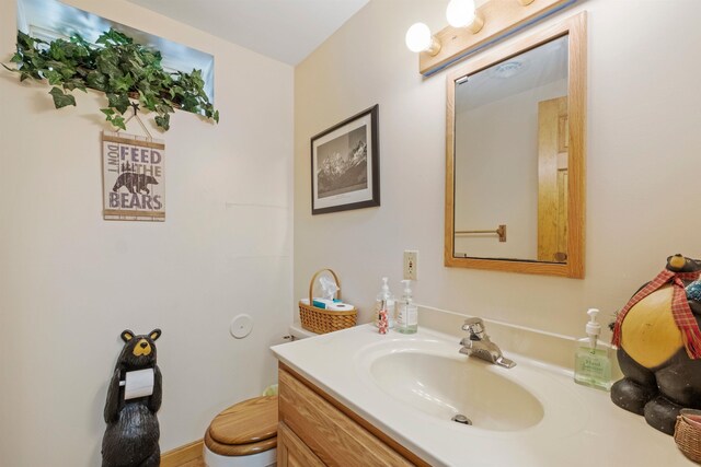 bathroom featuring toilet and vanity