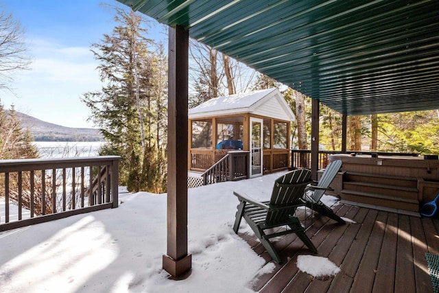 snow covered deck with a sunroom