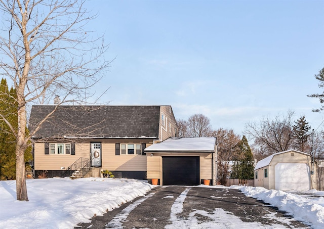 view of front of house featuring a storage unit and a garage