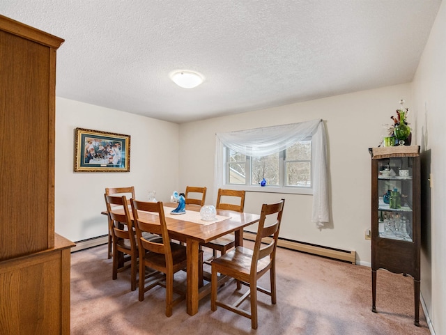 dining space featuring a textured ceiling, baseboard heating, and carpet floors