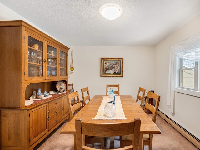 carpeted dining space with a textured ceiling and a baseboard radiator