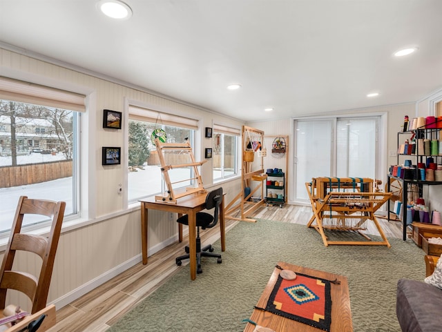 office area with ornamental molding and light hardwood / wood-style floors