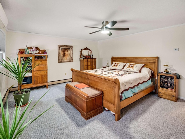 carpeted bedroom with a baseboard heating unit, ceiling fan, and crown molding