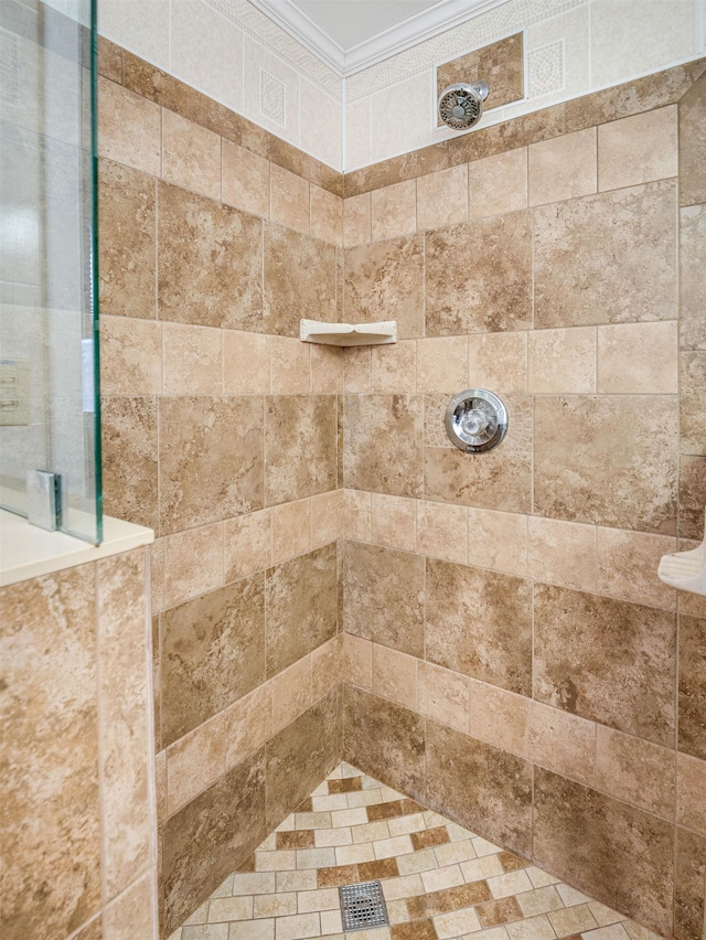 interior space with crown molding and a tile shower