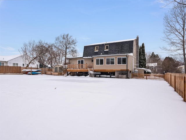 snow covered property with a deck