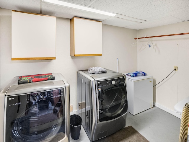 laundry room featuring cabinets and separate washer and dryer