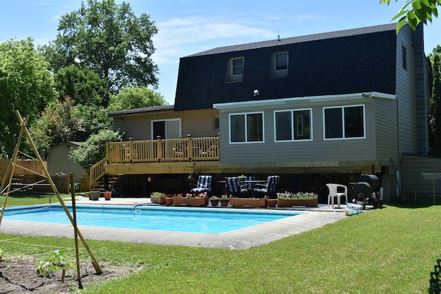 rear view of property with a lawn and a pool side deck