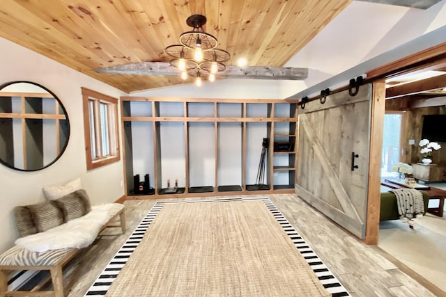 interior space with wood ceiling, a chandelier, a barn door, and vaulted ceiling with beams