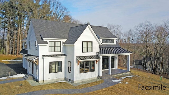 view of front of house featuring covered porch and a front yard