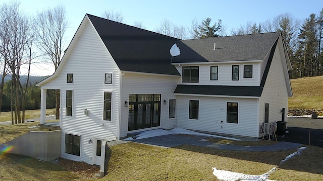 rear view of property featuring a yard