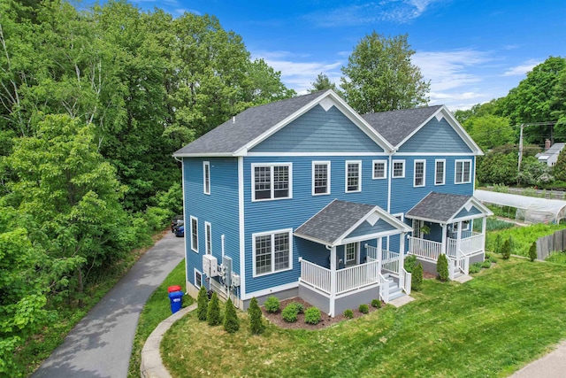 view of front of house with a front yard and a porch