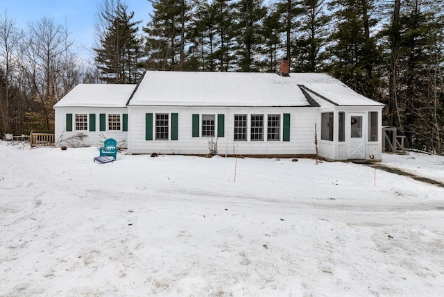 view of snow covered back of property