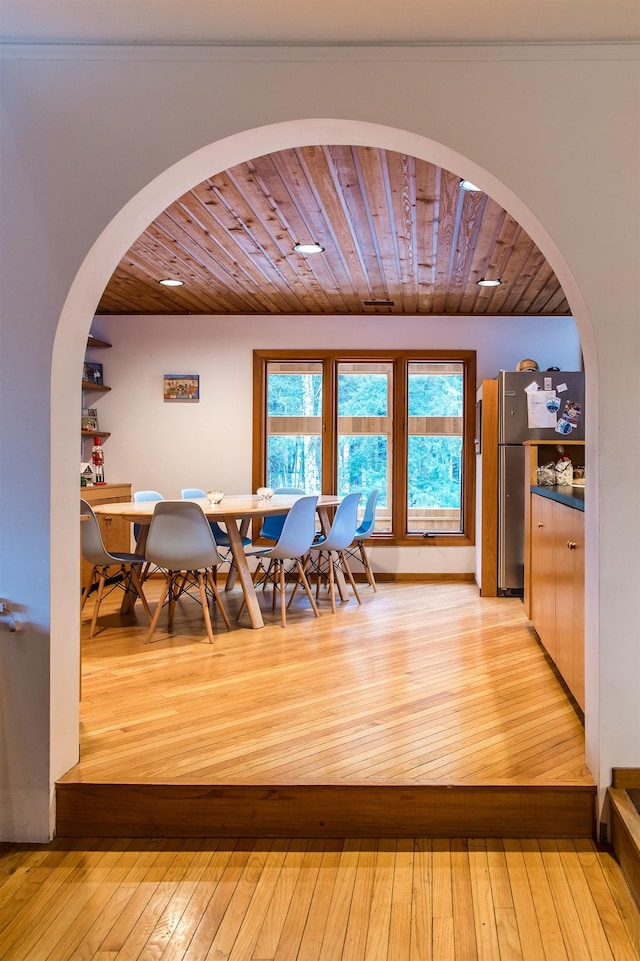 dining room with wooden ceiling and light hardwood / wood-style floors