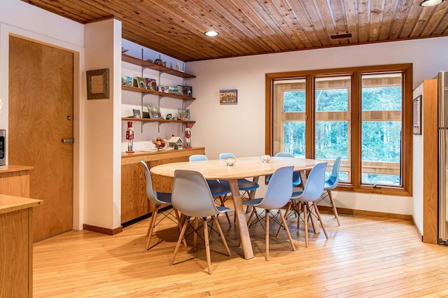 dining space featuring light hardwood / wood-style floors and wood ceiling