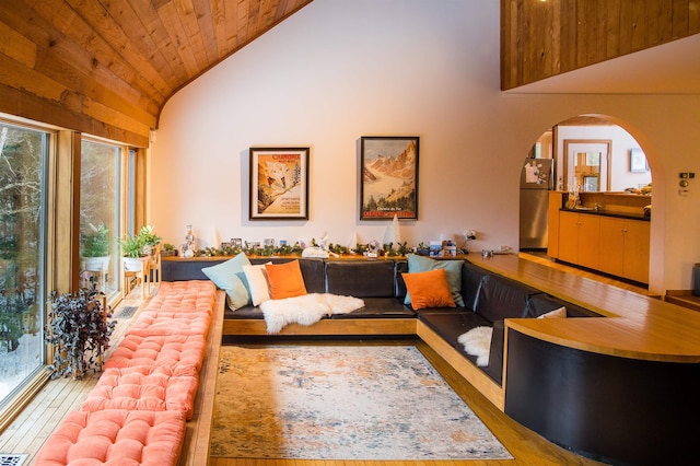 living room featuring wood ceiling, light hardwood / wood-style flooring, and high vaulted ceiling