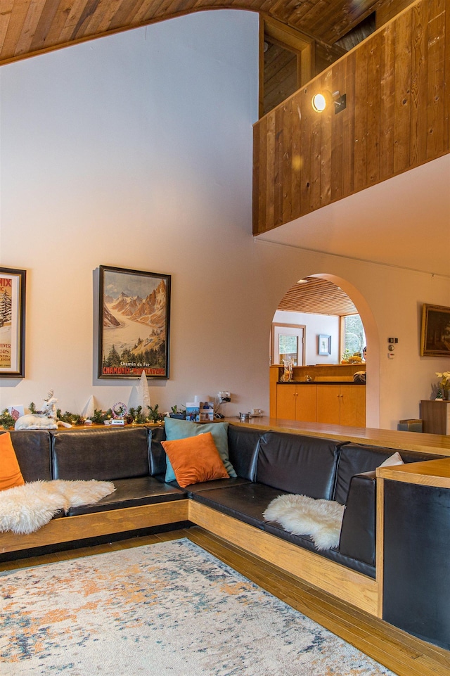 living room with wood ceiling and a towering ceiling