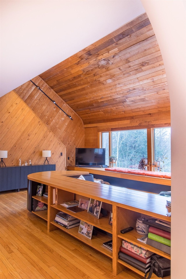 additional living space featuring light hardwood / wood-style floors, lofted ceiling, wood ceiling, and wooden walls