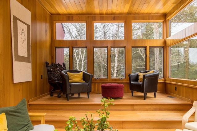 sunroom with a healthy amount of sunlight and wood ceiling