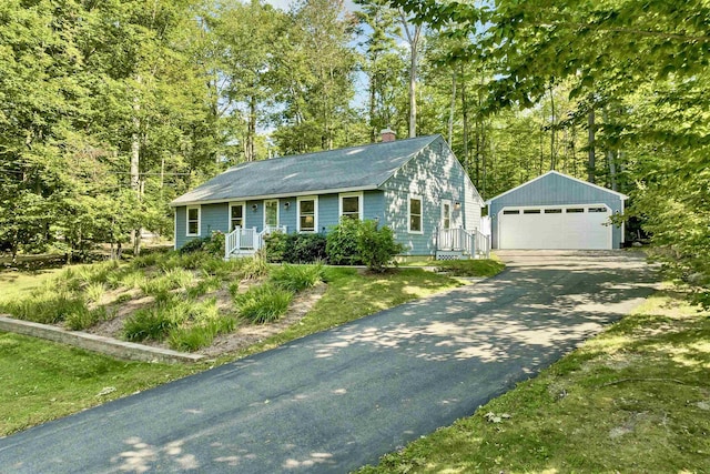 ranch-style home with a garage and an outbuilding