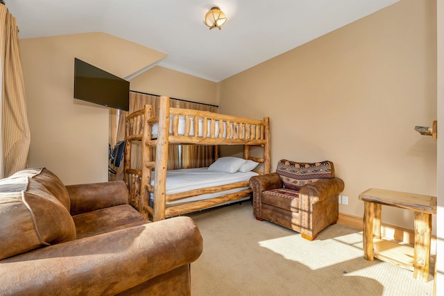 bedroom featuring light carpet and lofted ceiling