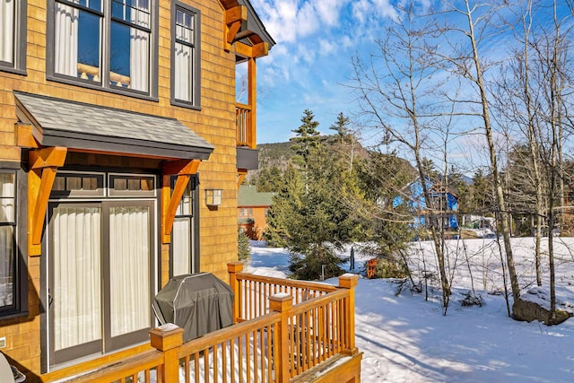 snow covered deck featuring area for grilling