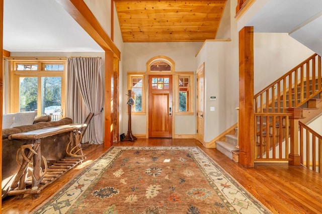 foyer entrance with light wood-type flooring, wooden ceiling, and lofted ceiling