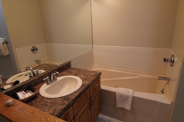 bathroom featuring a bathing tub, tile patterned floors, and vanity